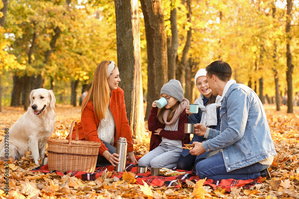 Happy family having picnic in autumn park Happy family having picnic in autumn park