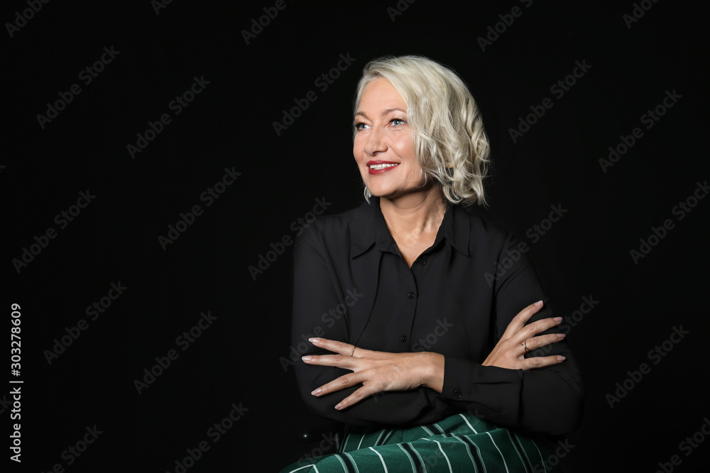 Portrait of stylish mature woman on dark background Portrait of stylish mature woman on dark background
