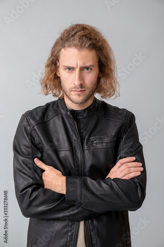 Portrait of handsome man on grey background