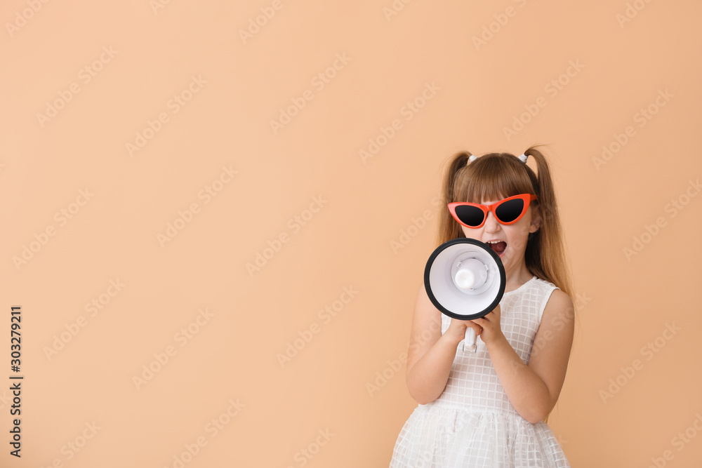 Fototapeta premium Cute little girl with megaphone on color background