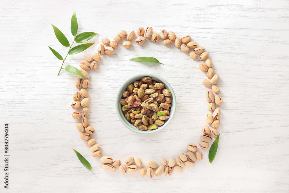 Composition with tasty pistachio nuts on table Composition with tasty pistachio nuts on table