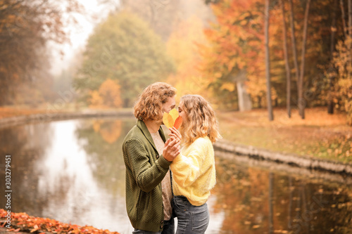 Young couple in park on aut...