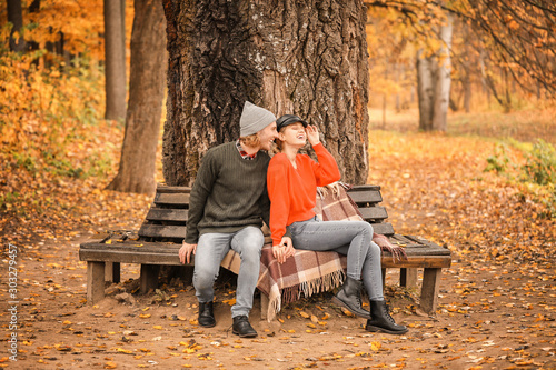 Young couple sitting on ben...