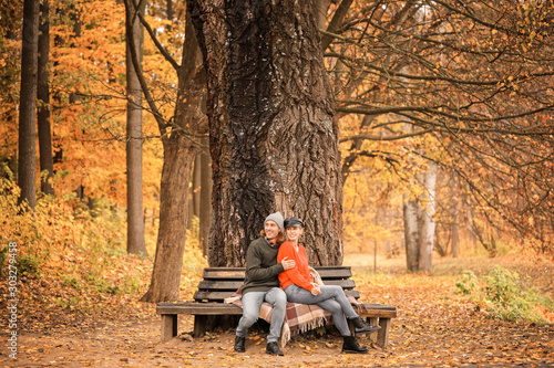 Young couple sitting on ben...