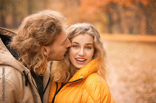 Young couple in park on aut...