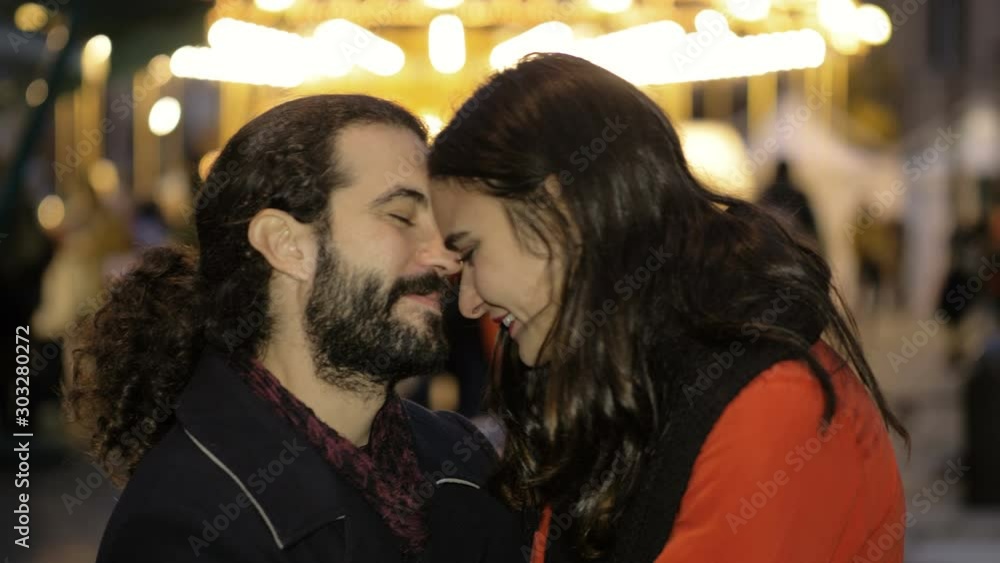 Romantic attractive young lovers flirting in the city at Christmas Romantic attractive young lovers flirting in the city at Christmas