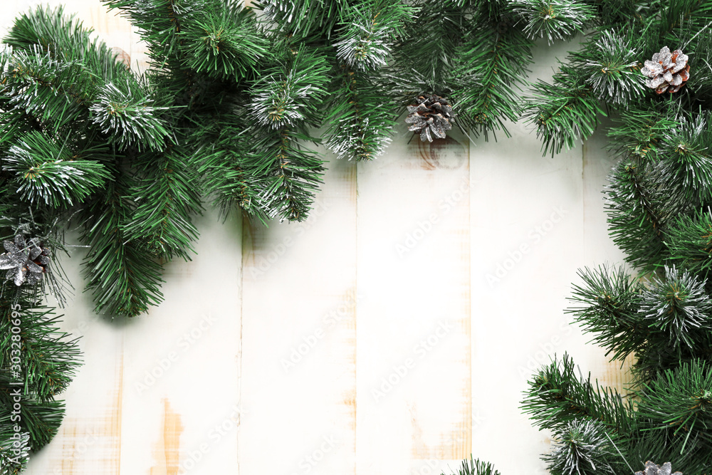 Beautiful fir branches on white wooden background Beautiful fir branches on white wooden background