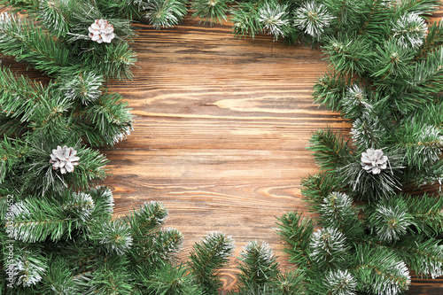 Composition with beautiful fir branches on wooden background