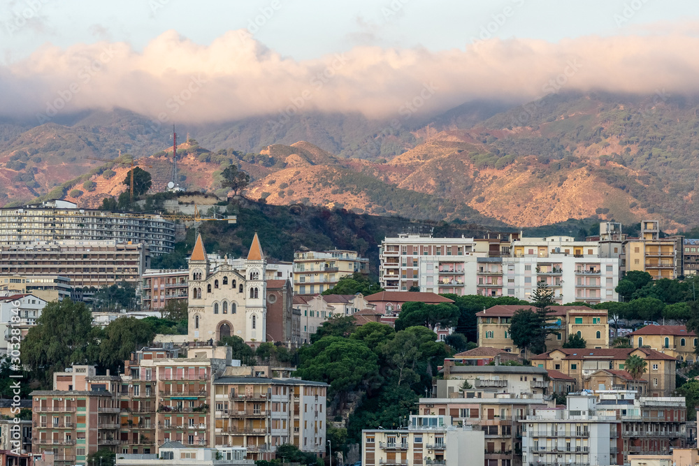 view on montalto chruch at sunrise at messina harbor, view on city center, italy