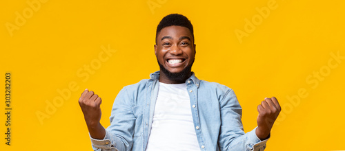 Принти на полотні Happy african american man rejoicing success with clenched fists