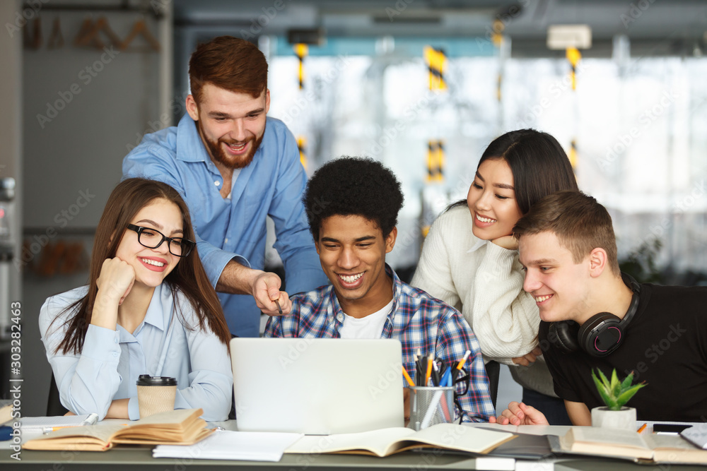 Education concept. University students using laptop in library Education concept. University students using laptop in library