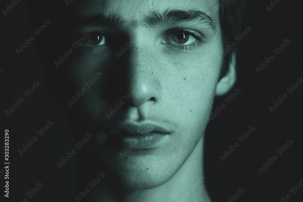 Portrait of a young man. Portrait of a handsome man, looking in the camera. Closeup face of a caucasian teenage boy. Confident and serious look of a teenager, at studio. Art style. Black and white. Portrait of a young man. Portrait of a handsome man, looking in the camera. Closeup face of a caucasian teenage boy. Confident and serious look of a teenager, at studio. Art style. Black and white.