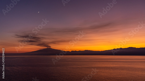 etna at sunset view from cruiseship, italy