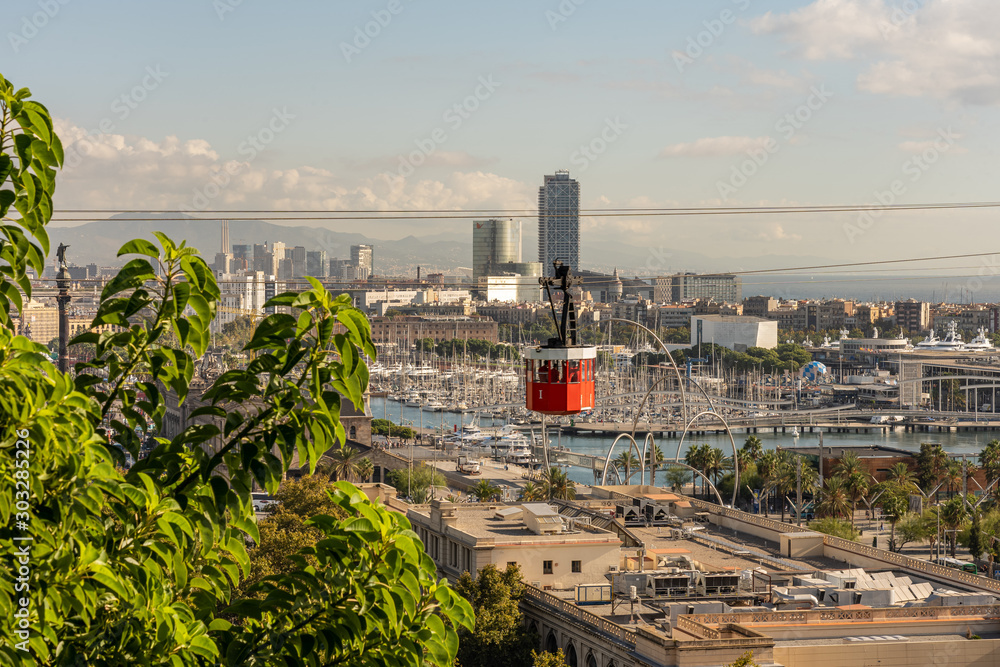 historic red cable car cabin, steel towers, harbor and Barcelona city, spain - obrazy, fototapety, plakaty 