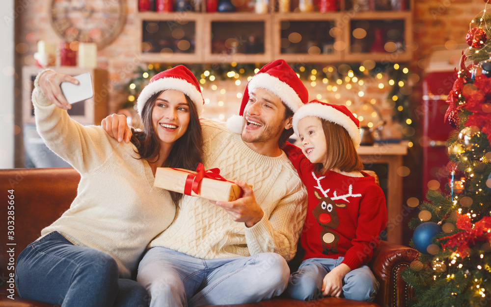 Emotional lovely family taking selfie with xmas gifts Emotional lovely family taking selfie with xmas gifts