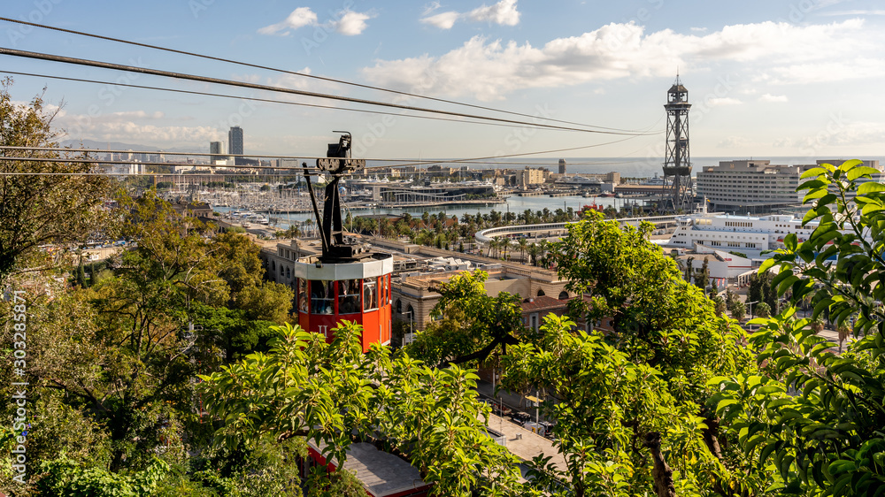 historic red cable car cabin with harbor and panorama of Barcelona city, spain - obrazy, fototapety, plakaty 