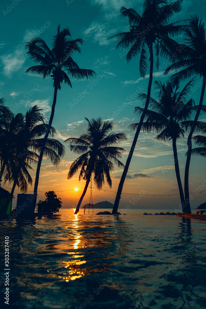 Beautiful poolside and sunset sky. Luxurious tropical beach landscape