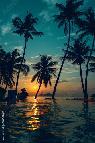 Beautiful poolside and sunset sky. Luxurious tropical beach landscape