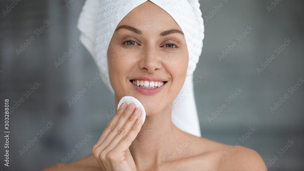 Smiling beautiful woman hold cotton pad cleansing face skin Smiling beautiful woman hold cotton pad cleansing face skin