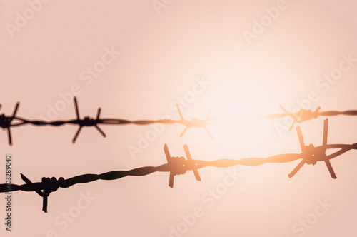 barbed wire on blue background © banlai