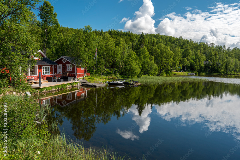 Typical Norvegian house in the border of the lake Lille Trollvatnet. Nordland, Norway. Typical Norvegian house in the border of the lake Lille Trollvatnet. Nordland, Norway.