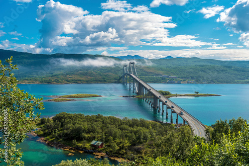 The Tjeldsund Bridge through Tjeldsundet strait viewed from Hinnoya Island, the mainland of Norwegian Troms county is at background. photo