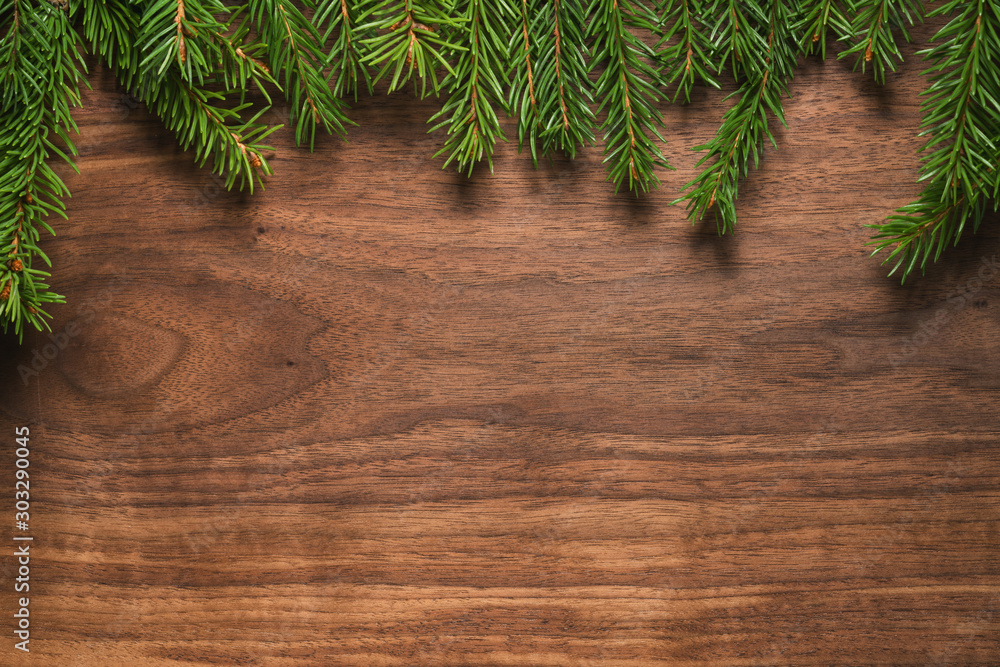 Top view of green spruce twigs on walnut wood surface Top view of green spruce twigs on walnut wood surface