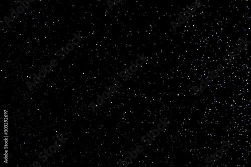 Realistic falling snowflakes. Isolated on black background.