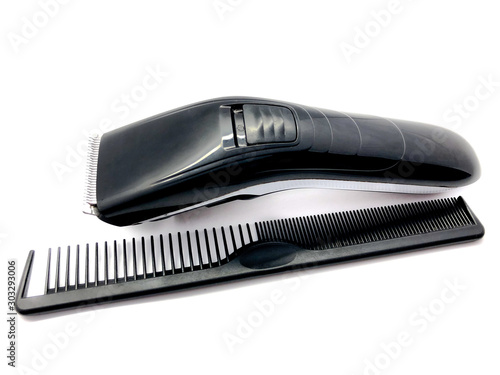 Barber hair clipper and black comb isolated on white background. Men's hairdresser tool. Set of hairdressing tools for a beauty salon. Typewriter and comb