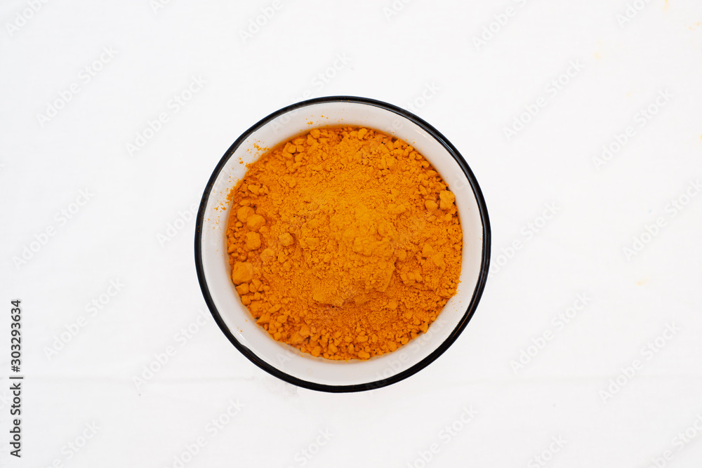 Turmeric Powder in bowl, directly above Turmeric Powder in bowl, directly above