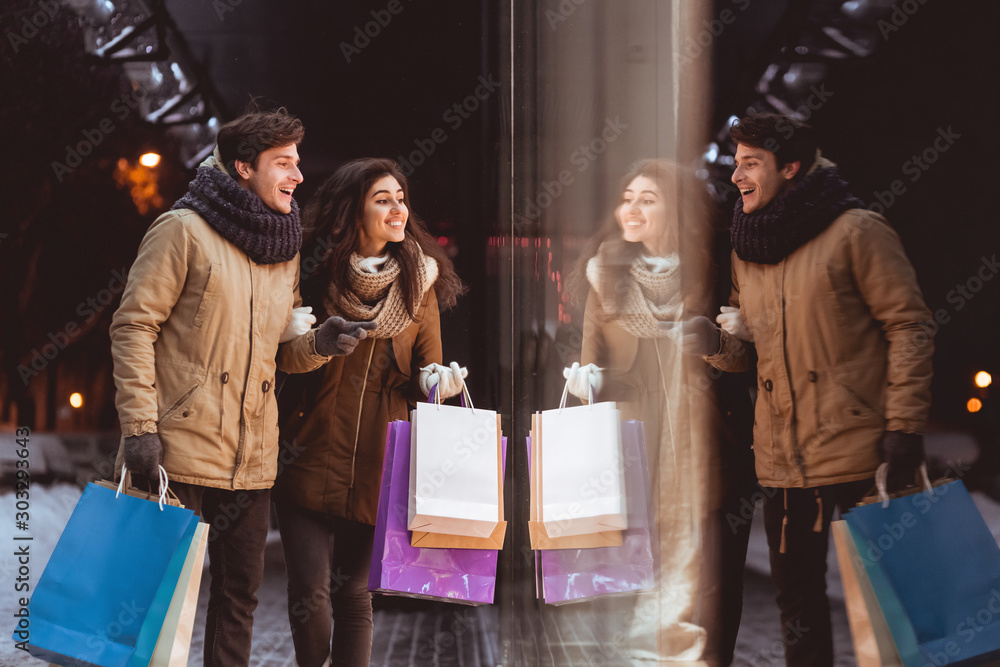 Spouses Looking At Shopwindow Shopping In Night City In Winter Stock ...