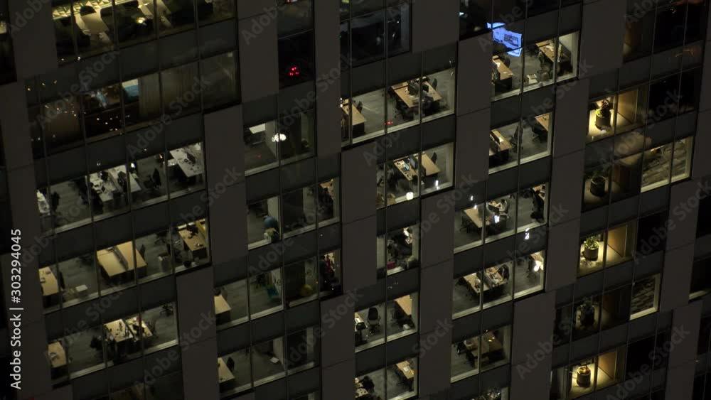 TOKYO, JAPAN : View of exterior of office building at night. Close up shot of glass window. TOKYO, JAPAN : View of exterior of office building at night. Close up shot of glass window.