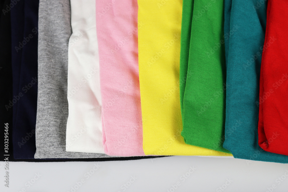 stack of colorful t-shirts on white stack of colorful t-shirts on white