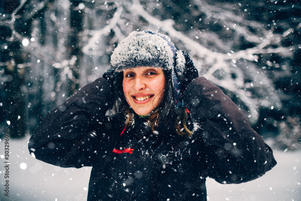 Woman with furry hat in cold winter landscape Woman with furry hat in cold winter landscape