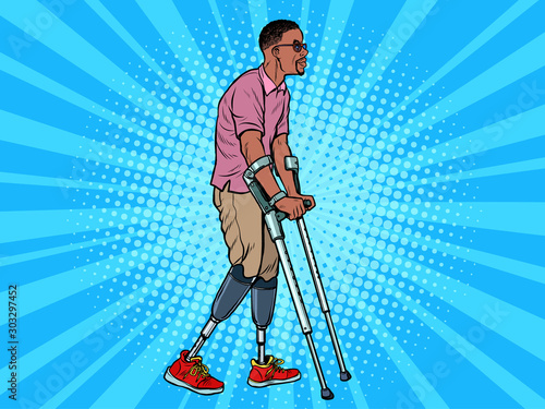 legless african veteran with a bionic prosthesis with crutches. a disabled man learns to walk after an injury. rehabilitation treatment and recovery