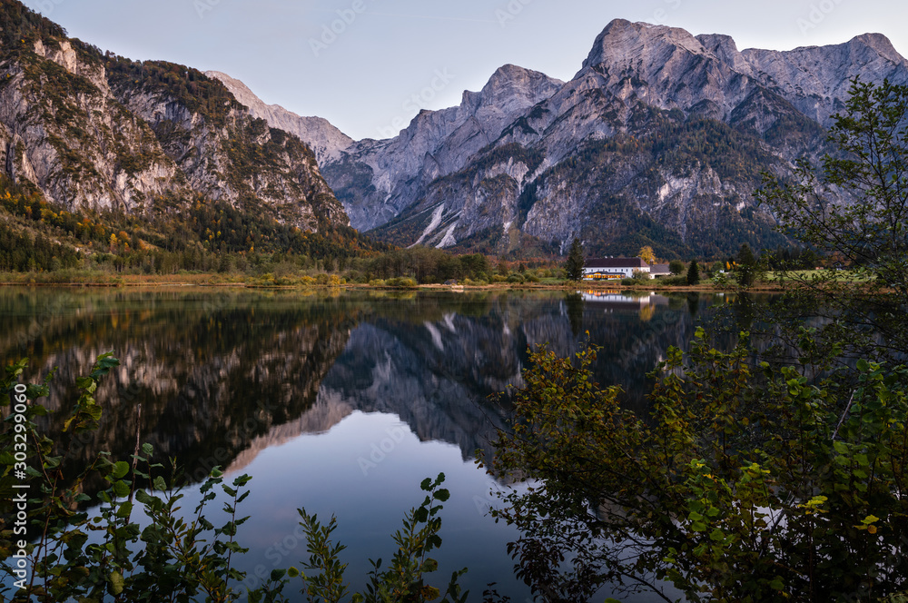 Autumn evening Alps mountain lake with clear transparent water and reflections. Almsee lake, Upper Austria.