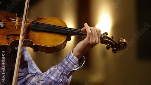 Close - up of a man playing the violin. Violinist's hands