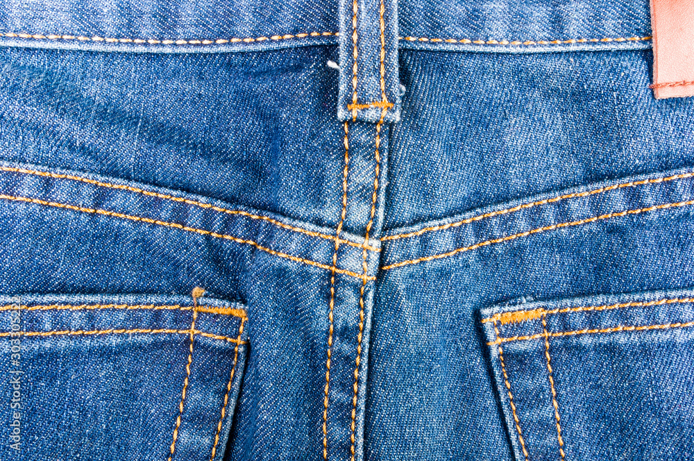 clothing items blue stonewashed faded jeans cotton fabric texture with seams, clasps, buttons and rivets, macro, close-up clothing items blue stonewashed faded jeans cotton fabric texture with seams, clasps, buttons and rivets, macro, close-up