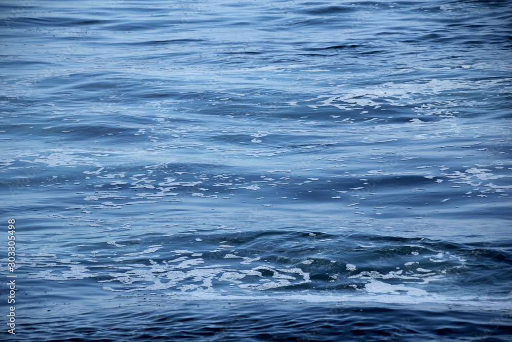 blue sea, ocean waves, water with foam and bubbles, texture, water natural resources concept, close-up, copy space blue sea, ocean waves, water with foam and bubbles, texture, water natural resources concept, close-up, copy space