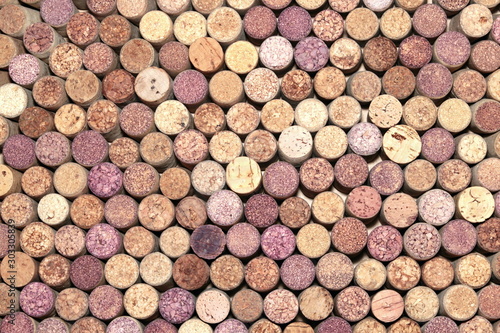 Abstract background of used red and white wine corks with corkscrew