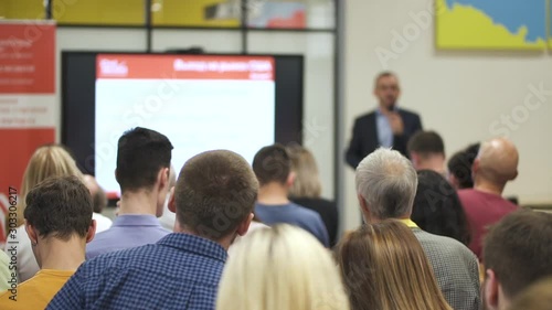 Wallpaper Mural American team leader presenting financial project for people at conference in office interior. Group of employees sitting in training class and listening business coach in room with screen. Concept Torontodigital.ca