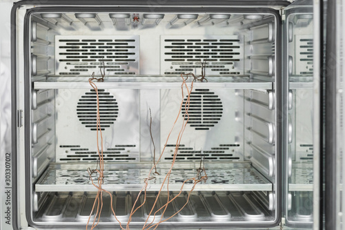 Inside of incubator with thermocouple probes installed for calibtlration in laboratory. photo