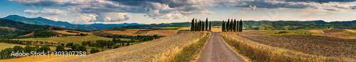 Beautiful Tuscany landscape panorama with cypress trees, road and mountain 