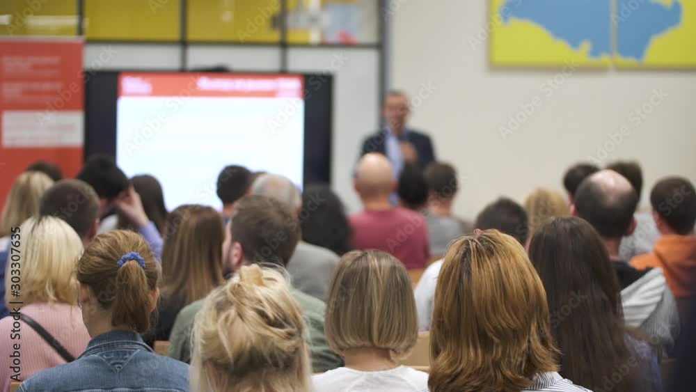 custom made wallpaper toronto digitalAmerican businessman talking speach for group people at conference in modern company. Young leader tells ans shows presentation on screen at business meeting. Man and woman listening lecture about new