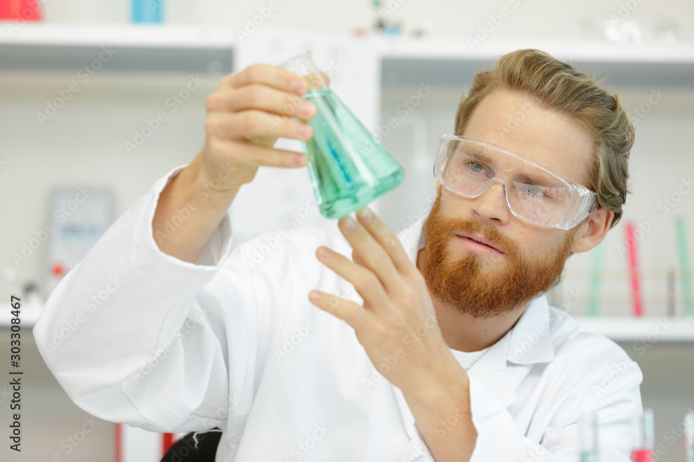 handsome student of chemistry working with chemicals handsome student of chemistry working with chemicals