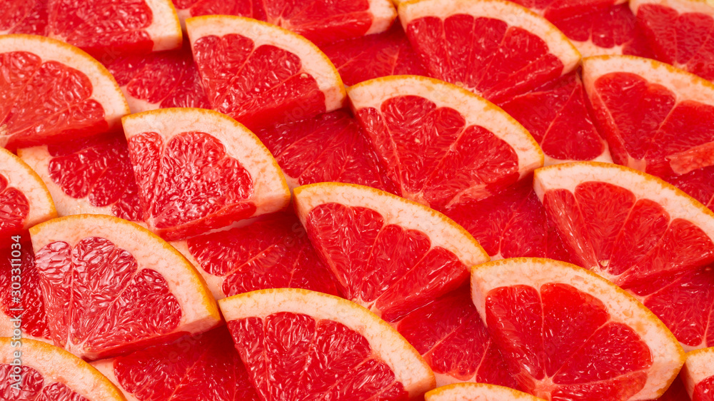 Grapefruit red juicy slices background. top view. Grapefruit red juicy slices background. top view.