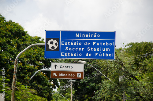 Street Sign of Mineirão Soccer Stadium trilingual with text: Mineirão Soccer Stadium. The second sign text: Downtown and Mineirão photo