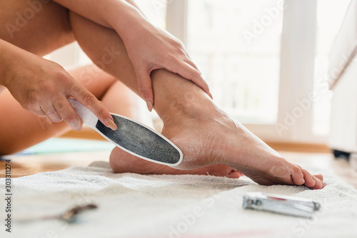 Woman having pedicure to her legs. Treatment of feet and nails. photo