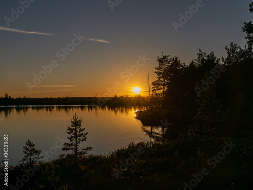 beautiful landscape with swamp lake at sunset, beautiful reflections of calm blurred lake water