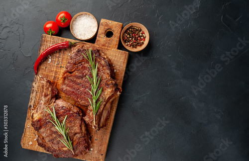 Cuadro en lienzo two grilled beef steaks with spices on a stone background with copy space